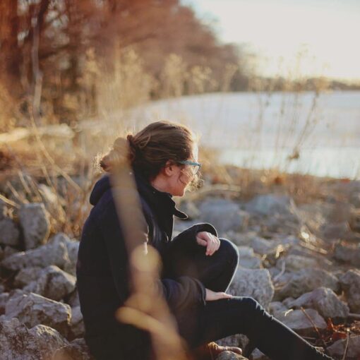 woman-sitting-beside-river