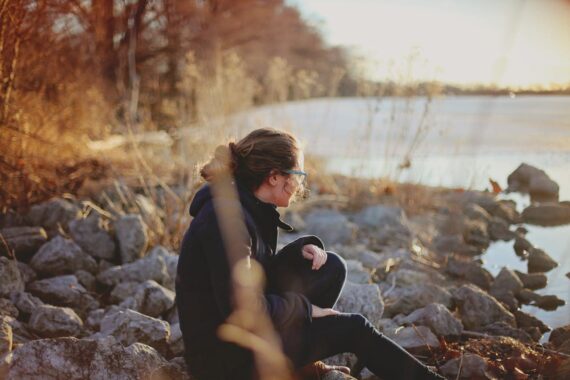 woman-sitting-beside-river