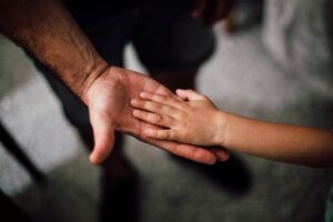 father-and-child-s-hands-together