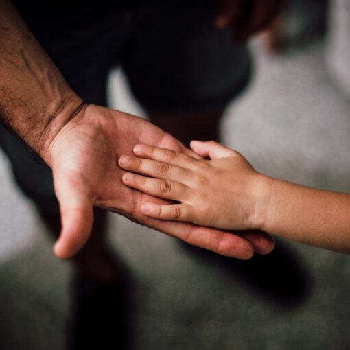 father-and-child-s-hands-together