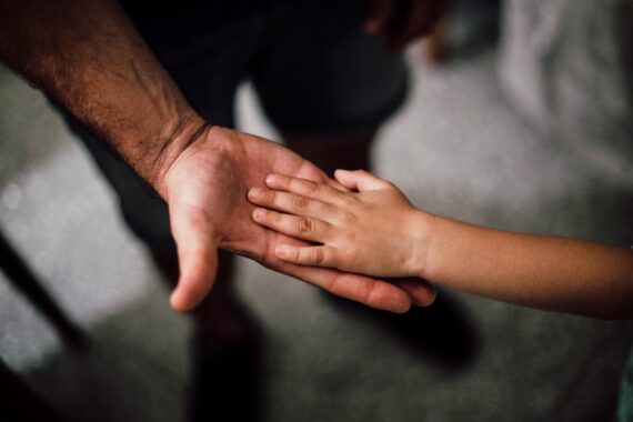 father-and-child-s-hands-together