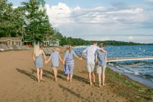 family-walking-on-the-beach-holding-hands