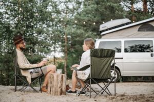 man-and-woman-having-conversation-while-sitting-on-folding-chairs