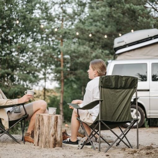 man-and-woman-having-conversation-while-sitting-on-folding-chairs